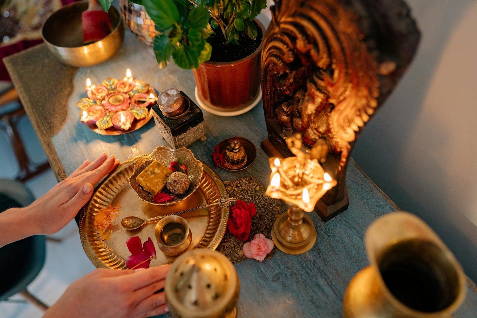 a person putting golden plate with food on the altar